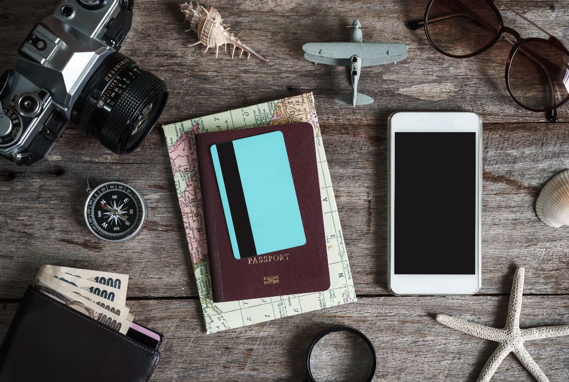 Travel essentials with a debit/credit card in the middle